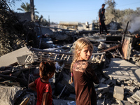 Palestinians inspect a house damaged in an Israeli airstrike in Deir al-Balah, central Gaza Strip, on October 4, 2024, amid the ongoing war...