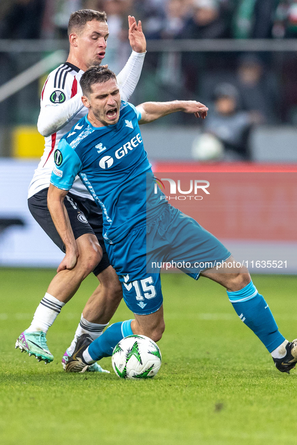 Kacper Chodyna and Romain Perraud  are playing during UEFA Conference League match between Legia Warsaw and Real Betis in Warsaw Poland on 3...