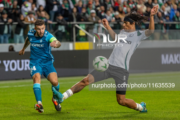 Aitor Ruibal and Maximillian Oyedele  are playing during UEFA Conference League match between Legia Warsaw and Real Betis in Warsaw Poland o...