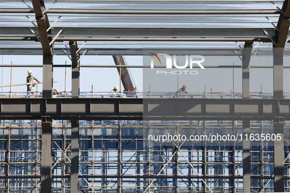 Workers work at the construction site of a standardized factory in Sihong Economic Development Zone in Suqian, Jiangsu province, China, on O...