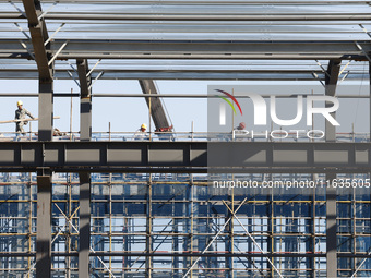 Workers work at the construction site of a standardized factory in Sihong Economic Development Zone in Suqian, Jiangsu province, China, on O...