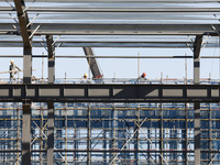 Workers work at the construction site of a standardized factory in Sihong Economic Development Zone in Suqian, Jiangsu province, China, on O...