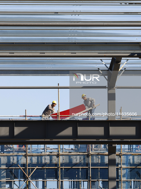 Workers work at the construction site of a standardized factory in Sihong Economic Development Zone in Suqian, Jiangsu province, China, on O...