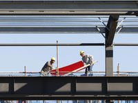 Workers work at the construction site of a standardized factory in Sihong Economic Development Zone in Suqian, Jiangsu province, China, on O...