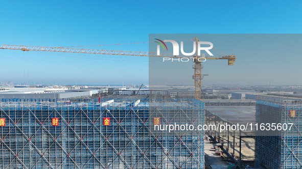 Workers work at the construction site of a standardized factory in Sihong Economic Development Zone in Suqian, Jiangsu province, China, on O...