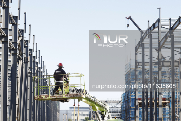 Workers work at the construction site of a standardized factory in Sihong Economic Development Zone in Suqian, Jiangsu province, China, on O...