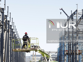 Workers work at the construction site of a standardized factory in Sihong Economic Development Zone in Suqian, Jiangsu province, China, on O...