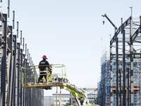 Workers work at the construction site of a standardized factory in Sihong Economic Development Zone in Suqian, Jiangsu province, China, on O...