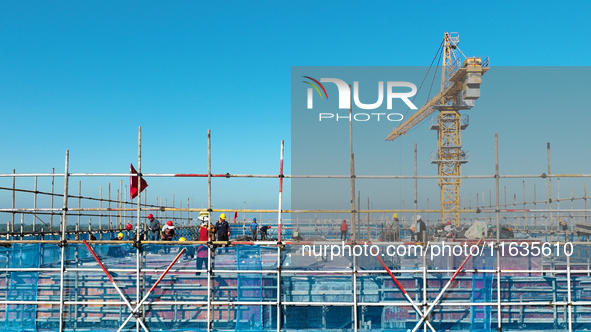 Workers work at the construction site of a standardized factory in Sihong Economic Development Zone in Suqian, Jiangsu province, China, on O...