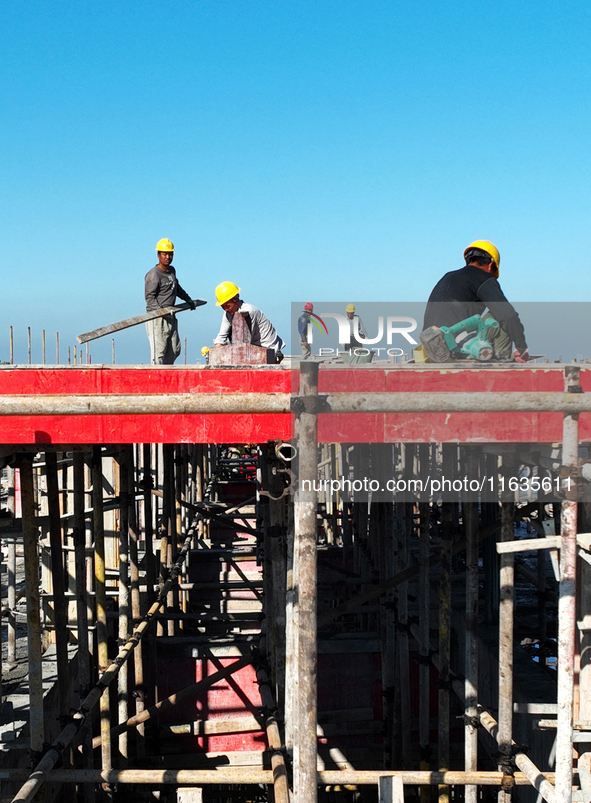 Workers work at the construction site of a standardized factory in Sihong Economic Development Zone in Suqian, Jiangsu province, China, on O...