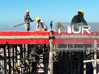 Workers work at the construction site of a standardized factory in Sihong Economic Development Zone in Suqian, Jiangsu province, China, on O...