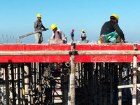 Workers work at the construction site of a standardized factory in Sihong Economic Development Zone in Suqian, Jiangsu province, China, on O...