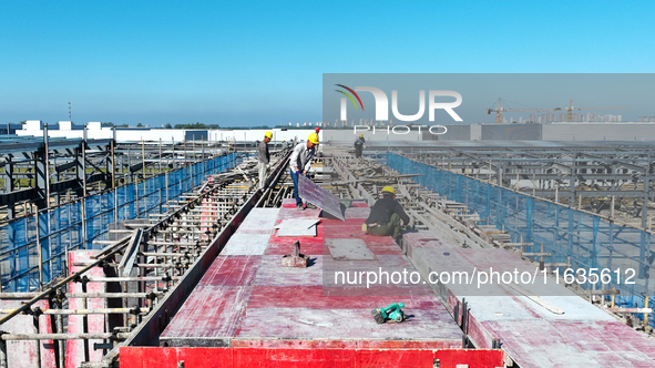 Workers work at the construction site of a standardized factory in Sihong Economic Development Zone in Suqian, Jiangsu province, China, on O...