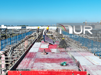 Workers work at the construction site of a standardized factory in Sihong Economic Development Zone in Suqian, Jiangsu province, China, on O...