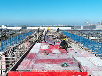 Workers work at the construction site of a standardized factory in Sihong Economic Development Zone in Suqian, Jiangsu province, China, on O...