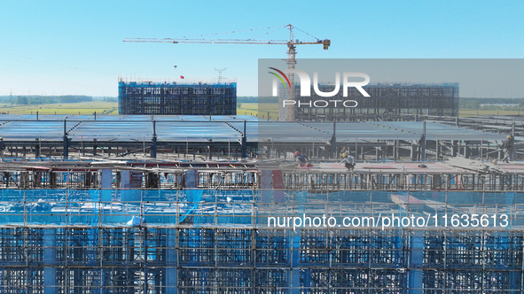 Workers work at the construction site of a standardized factory in Sihong Economic Development Zone in Suqian, Jiangsu province, China, on O...