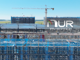 Workers work at the construction site of a standardized factory in Sihong Economic Development Zone in Suqian, Jiangsu province, China, on O...