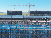 Workers work at the construction site of a standardized factory in Sihong Economic Development Zone in Suqian, Jiangsu province, China, on O...