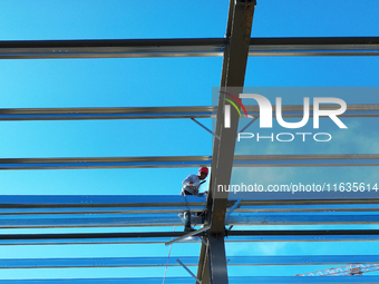 Workers work at the construction site of a standardized factory in Sihong Economic Development Zone in Suqian, Jiangsu province, China, on O...