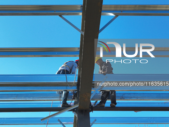 Workers work at the construction site of a standardized factory in Sihong Economic Development Zone in Suqian, Jiangsu province, China, on O...