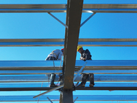 Workers work at the construction site of a standardized factory in Sihong Economic Development Zone in Suqian, Jiangsu province, China, on O...