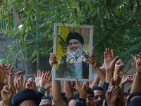 A Kashmiri Shia Muslim boy holds a placard of Hezbollah leader Sayyed Hassan Nasrallah during a protest against Israel following the killing...