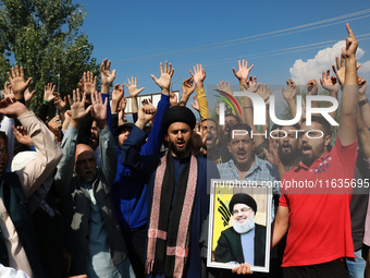 Kashmiri Shia Muslims shout slogans during a protest against Israel following the killing of Lebanon's Hezbollah leader Sayyed Hassan Nasral...