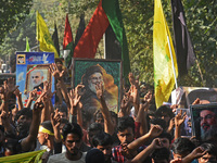 Shiite Muslims carry pictures of Hezbollah leader Hassan Nasrallah as they shout anti-Israel slogans during a demonstration to show their an...