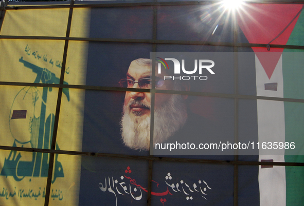 Shiite Muslims carry a picture of Hezbollah leader Hassan Nasrallah as they shout anti-Israel slogans during a demonstration to show their a...