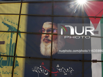 Shiite Muslims carry a picture of Hezbollah leader Hassan Nasrallah as they shout anti-Israel slogans during a demonstration to show their a...