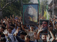 Shiite Muslims carry pictures of Hezbollah leader Hassan Nasrallah as they shout anti-Israel slogans during a demonstration to show their an...