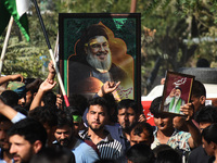 Shiite Muslims carry pictures of Hezbollah leader Hassan Nasrallah as they shout anti-Israel slogans during a demonstration to show their an...