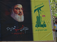 Shiite Muslims carry pictures of Hezbollah leader Hassan Nasrallah as they shout anti-Israel slogans during a demonstration to show their an...