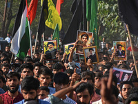 Shiite Muslims carry pictures of Hezbollah leader Hassan Nasrallah as they shout anti-Israel slogans during a demonstration to show their an...