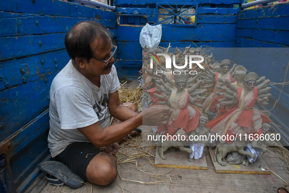 An artist packs small idols of Goddess Durga for transportation ahead of the Durga Puja festival in Kolkata, India, on October 4, 2024. 