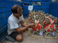 An artist packs small idols of Goddess Durga for transportation ahead of the Durga Puja festival in Kolkata, India, on October 4, 2024. (