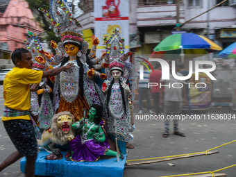 Laborers carry an idol of Goddess Durga to her pandal ahead of the Durga Puja festival in Kolkata, India, on October 2024. (