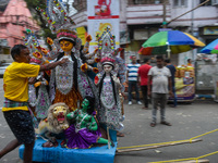 Laborers carry an idol of Goddess Durga to her pandal ahead of the Durga Puja festival in Kolkata, India, on October 2024. (