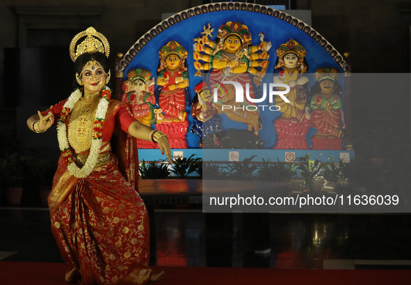 A dancer performs the ''Durgotsab'' dance dressed as goddess Durga ahead of the Durga Puja festival inside the historic Victoria Memorial mo...