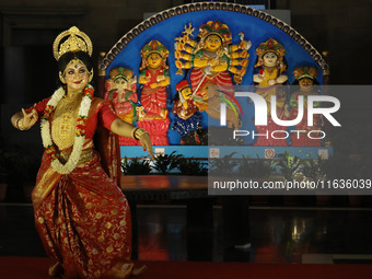 A dancer performs the ''Durgotsab'' dance dressed as goddess Durga ahead of the Durga Puja festival inside the historic Victoria Memorial mo...