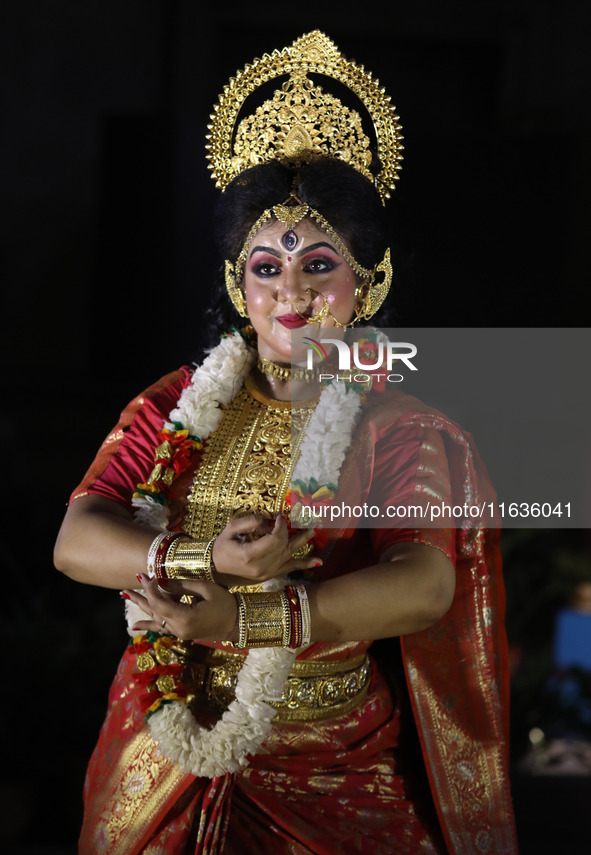 A dancer performs the ''Durgotsab'' dance dressed as goddess Durga ahead of the Durga Puja festival inside the historic Victoria Memorial mo...