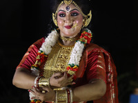 A dancer performs the ''Durgotsab'' dance dressed as goddess Durga ahead of the Durga Puja festival inside the historic Victoria Memorial mo...