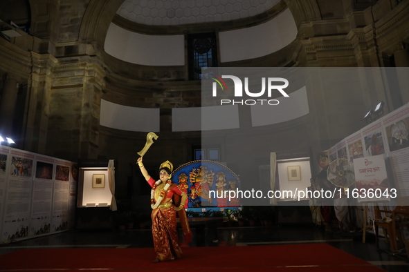 A dancer performs the ''Durgotsab'' dance dressed as goddess Durga ahead of the Durga Puja festival inside the historic Victoria Memorial mo...