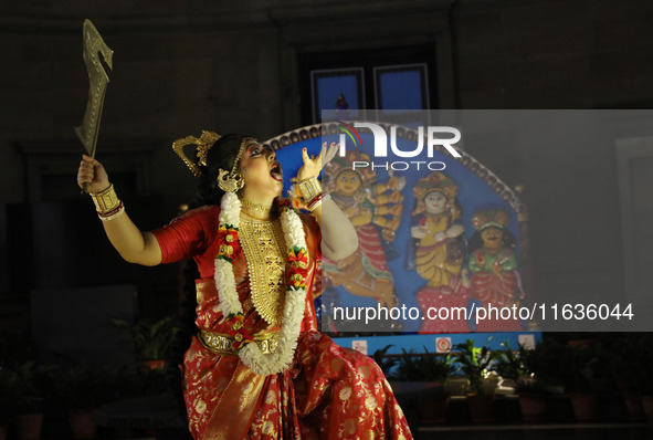 A dancer performs the ''Durgotsab'' dance dressed as goddess Durga ahead of the Durga Puja festival inside the historic Victoria Memorial mo...