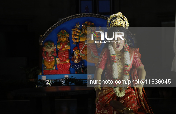 A dancer performs the ''Durgotsab'' dance dressed as goddess Durga ahead of the Durga Puja festival inside the historic Victoria Memorial mo...