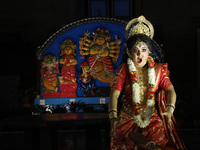 A dancer performs the ''Durgotsab'' dance dressed as goddess Durga ahead of the Durga Puja festival inside the historic Victoria Memorial mo...