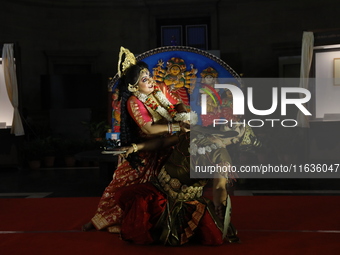 A performer performs the ''Durgotsab'' dance dressed as goddess Durga ahead of the Durga Puja festival inside the historic Victoria Memorial...