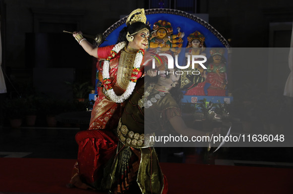 Dancers perform the ''Durgotsab'' dance dressed as goddess Durga and a demon ahead of the Durga Puja festival inside the historic Victoria M...