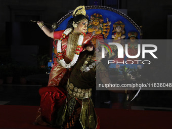 Dancers perform the ''Durgotsab'' dance dressed as goddess Durga and a demon ahead of the Durga Puja festival inside the historic Victoria M...