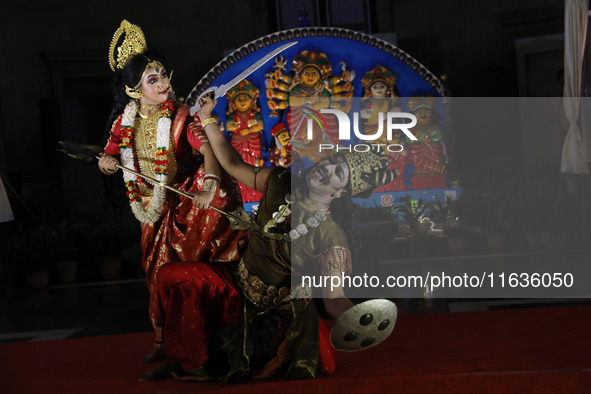 Dancers perform the ''Durgotsab'' dance dressed as goddess Durga and a demon ahead of the Durga Puja festival inside the historic Victoria M...